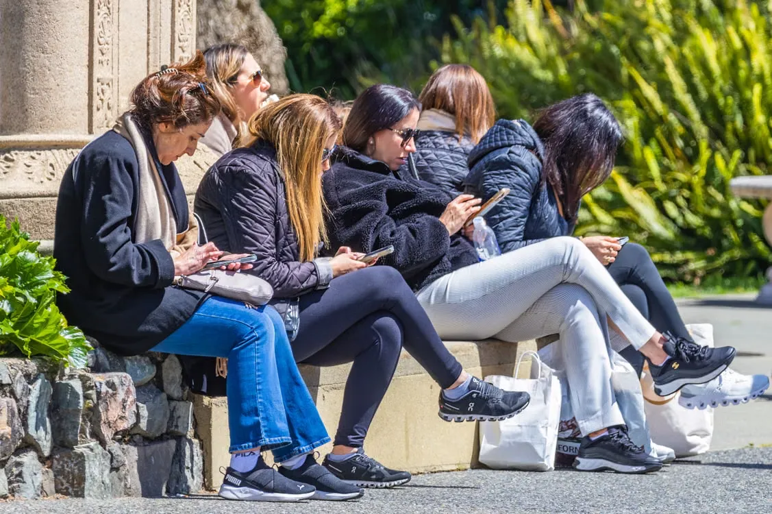a group of people staring at their phones